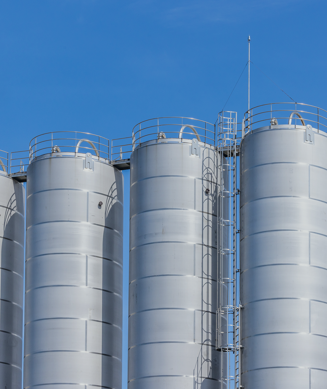 LNG storage tanks against a blue sky